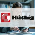 Das Logo der Hüthig GmbH vor einer Frau, die auf einem Mobiltelefon liest